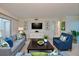 Comfortable living room showcasing a large TV, cozy seating, and a walk-out balcony at 3680 Ironwood Cir # 603L, Bradenton, FL 34209
