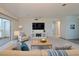 Bright living room with large TV, comfortable seating, and access to a balcony at 3680 Ironwood Cir # 603L, Bradenton, FL 34209
