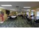The community meeting room features ample seating, a TV, and neutral walls at 3680 Ironwood Cir # 603L, Bradenton, FL 34209