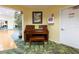 Aesthetic lobby featuring a Baldwin piano, tropical leafy carpet, and an Automated External Defibrillator at 3680 Ironwood Cir # 603L, Bradenton, FL 34209