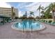 Outdoor pool surrounded by lounge chairs, lush landscaping and manicured grounds at this residence at 3680 Ironwood Cir # 603L, Bradenton, FL 34209
