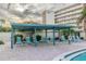 Poolside pergola with lounge chairs, offering a shaded retreat next to the pool for ultimate relaxation at 3680 Ironwood Cir # 603L, Bradenton, FL 34209