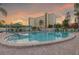 Sparkling community pool with lounge chairs and serene setting at 3680 Ironwood Cir # 603L, Bradenton, FL 34209