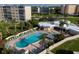 Aerial shot showcases a sparkling pool, lounge chairs, and the clubhouse, perfect for relaxation and socializing at 3680 Ironwood Cir # 603L, Bradenton, FL 34209