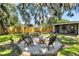 This backyard features a fire pit with Adirondack chairs and a fully fenced yard for added privacy at 4041 Linwood St, Sarasota, FL 34232