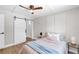 Cozy bedroom with wood floors, ceiling fan, barn door to closet, and stylish decor at 4041 Linwood St, Sarasota, FL 34232