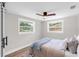 Well-lit bedroom with windows, ceiling fan, and modern gray color scheme at 4041 Linwood St, Sarasota, FL 34232
