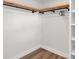Walk-in closet includes custom wood shelving and black pipe hanging rods at 4041 Linwood St, Sarasota, FL 34232