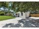 Side angle of the home with fresh gravel driveway and a new fence along the back of the property at 4041 Linwood St, Sarasota, FL 34232