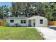 Charming single-story home with a freshly painted exterior, landscaping, and a welcoming teal front door at 4041 Linwood St, Sarasota, FL 34232