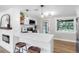 Modern kitchen featuring white cabinetry, sleek countertops, and a bar area overlooking the living room at 4041 Linwood St, Sarasota, FL 34232