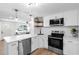 Bright kitchen with white cabinetry, stainless appliances, light countertops, and wood-look flooring at 4041 Linwood St, Sarasota, FL 34232