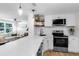 Bright, updated kitchen with white cabinets, quartz countertops, and stainless steel appliances at 4041 Linwood St, Sarasota, FL 34232