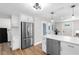 Updated kitchen with stainless steel refrigerator, modern cabinets, and wood flooring at 4041 Linwood St, Sarasota, FL 34232