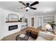 Bright living room featuring wood-look floors, stylish furniture, and an electric fireplace at 4041 Linwood St, Sarasota, FL 34232