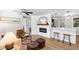 Living room showcasing an electric fireplace, wood-look flooring, and bar seating into the kitchen at 4041 Linwood St, Sarasota, FL 34232
