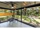 Outdoor patio with ceiling fan, dining table set and backyard fire pit with chairs at 4041 Linwood St, Sarasota, FL 34232