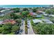 Community entrance with lush tropical landscaping and trees at 500 Park S Blvd # 97, Venice, FL 34285