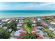 Aerial view of a beachfront community with red-roofed homes, mature trees, and a refreshing blue pool at 500 Park S Blvd # 97, Venice, FL 34285