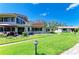 Lush backyard featuring a well-maintained lawn, patio with furniture, and the rear view of an inviting home at 500 Park S Blvd # 97, Venice, FL 34285