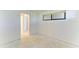 Bedroom featuring a window, white walls, and a doorway at 500 Park S Blvd # 97, Venice, FL 34285