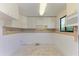Compact kitchen featuring ample cabinet space and decorative backsplash at 500 Park S Blvd # 97, Venice, FL 34285