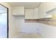 Compact kitchen with tiled backsplash, abundant cabinets, and connection to other rooms at 500 Park S Blvd # 97, Venice, FL 34285