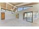 Open living room featuring vaulted ceilings, large windows, and seamless access to other spaces at 500 Park S Blvd # 97, Venice, FL 34285