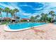 Large swimming pool surrounded by lounge chairs and a brick patio for community relaxation at 500 Park S Blvd # 97, Venice, FL 34285