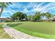 Manicured putting green with a brick walkway and lush landscaping for recreational enjoyment at 500 Park S Blvd # 97, Venice, FL 34285
