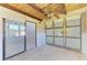 Enclosed sunroom featuring a wooden ceiling, large windows, and a sliding glass door at 500 Park S Blvd # 97, Venice, FL 34285