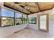 Enclosed sunroom featuring a wooden ceiling, large windows, door and a ceiling fan at 500 Park S Blvd # 97, Venice, FL 34285
