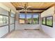 Enclosed sunroom featuring a wooden ceiling, large windows, and a ceiling fan at 500 Park S Blvd # 97, Venice, FL 34285