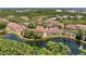 Beautiful aerial view of condo community with pond, lush greenery, and red tile roofs at 5001 Baraldi Cir # 22-202, Sarasota, FL 34235