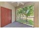 Balcony with screened enclosure offering views of the mature trees surrounding the home at 5001 Baraldi Cir # 22-202, Sarasota, FL 34235