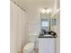 Bathroom with granite countertop vanity, white cabinets, and a shower with a curtain at 5001 Baraldi Cir # 22-202, Sarasota, FL 34235