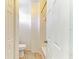 Bathroom featuring a toilet, and tiled shower tub, with door and neutral walls at 5001 Baraldi Cir # 22-202, Sarasota, FL 34235