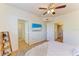 Bright bedroom featuring hardwood floors, ceiling fan, and a flat screen TV at 5001 Baraldi Cir # 22-202, Sarasota, FL 34235