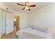 Cozy bedroom featuring hardwood floors and ceiling fan at 5001 Baraldi Cir # 22-202, Sarasota, FL 34235