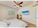 Bedroom with a window and flat screen tv with attached bathroom at 5001 Baraldi Cir # 22-202, Sarasota, FL 34235