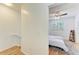 View into bedroom featuring hardwood floors, window, and ladder shelf at 5001 Baraldi Cir # 22-202, Sarasota, FL 34235