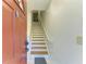Entryway with wooden stairs leading to the upper level of the home at 5001 Baraldi Cir # 22-202, Sarasota, FL 34235