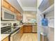 Kitchen featuring stainless steel appliances and a granite sink with a reverse view into the living room at 5001 Baraldi Cir # 22-202, Sarasota, FL 34235