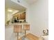 Kitchen pass-through with granite countertops and wooden barstools at 5001 Baraldi Cir # 22-202, Sarasota, FL 34235