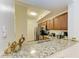 The kitchen features beautiful granite countertops, wood cabinetry, and stainless steel appliances at 5001 Baraldi Cir # 22-202, Sarasota, FL 34235