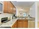Kitchen featuring granite counters, stainless appliances, and an open view to the living area at 5001 Baraldi Cir # 22-202, Sarasota, FL 34235