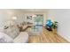 The expansive living room features wood floors, contemporary decor and a glass coffee table on a shag rug at 5001 Baraldi Cir # 22-202, Sarasota, FL 34235