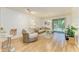 Comfortable living room showcasing the open layout with the granite kitchen pass-through, couches and outdoor access at 5001 Baraldi Cir # 22-202, Sarasota, FL 34235