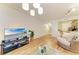 Inviting living room with hardwood floors and a view into the kitchen at 5001 Baraldi Cir # 22-202, Sarasota, FL 34235