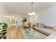 Open-concept living area with hardwood flooring and a view to the kitchen at 5001 Baraldi Cir # 22-202, Sarasota, FL 34235